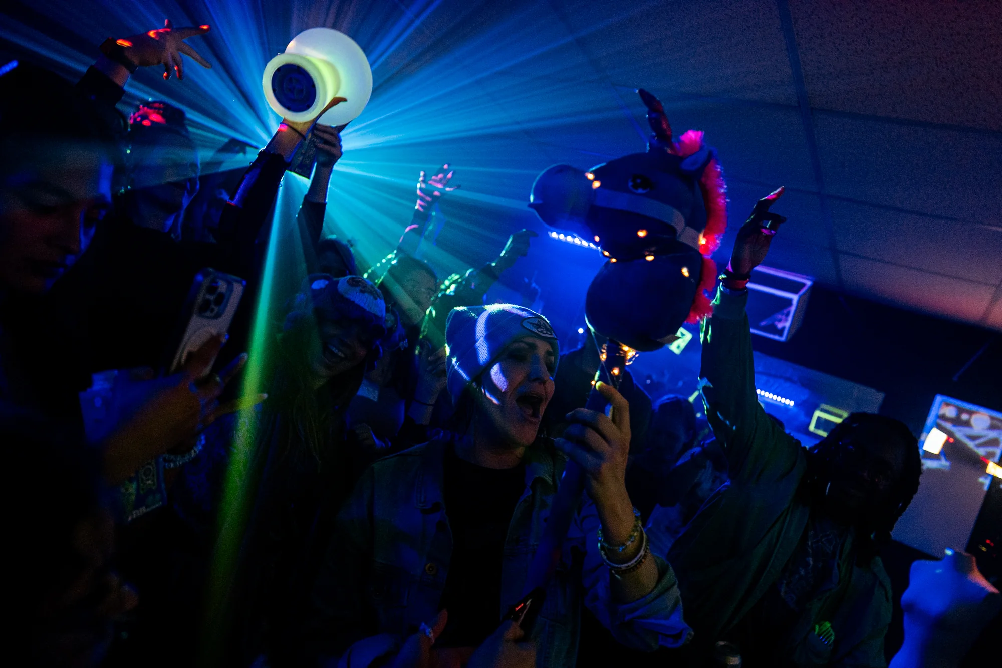 Friends laughing together in the front row under the projections